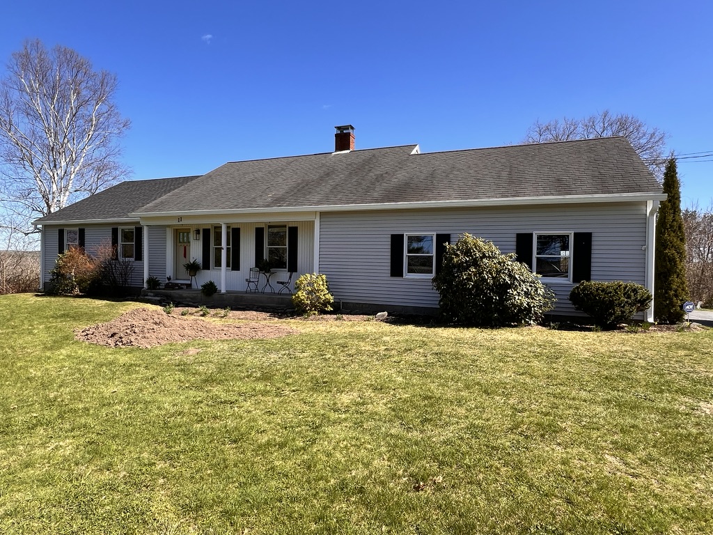 Ranch home with new white gutters under a clear blue sky
